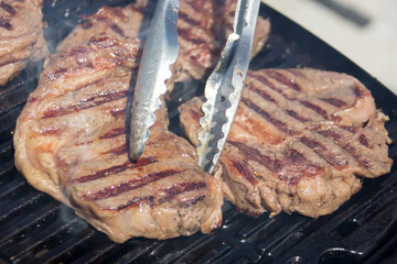 Grilled meat. Roasted piece of beef during cooking.