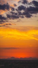 beautiful sunset with cloudy skies over the city and mountains 