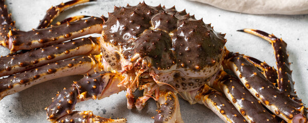 Kamchatka crab. King raw crab on the kitchen table. Kamchatka crab is on the table. Cooking process. Banner  © Liudmila Zavialova