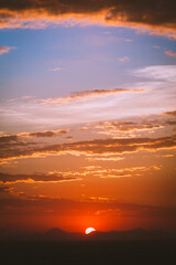 beautiful sunset with cloudy skies over the city and mountains 