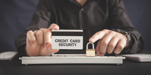 Man holding credit card and padlock. Credit card security