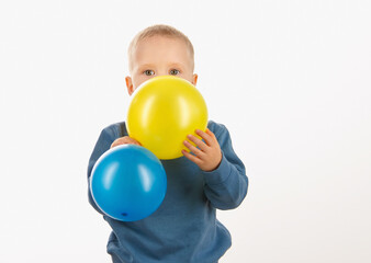 little boy child holding balloons, happy childhood. soft focus