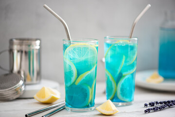 blue curacao cocktail with lemon slices in glasses