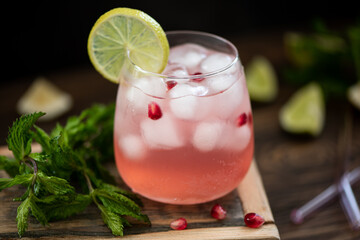 cocktail with pink lemonade and pomegranate seeds