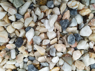 Raw rocks and minerals as natural stones background with crushed and rough material at a rough coast or rocky beach show nuggets and sandstones in harmonic pastel colors