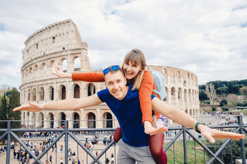 Happy young couple lover making selfie and smile Colosseum in Rome, Italy. Concept travel