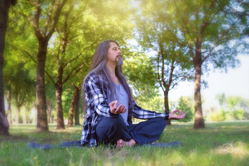 Man middle aged  meditating at the park