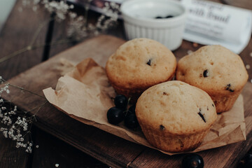 The tasty muffins with chocolate on a wooden desk. Muffins for perfect and beautiful breakfast. 