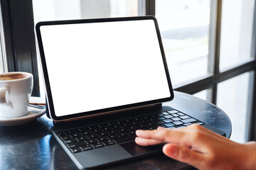 Mockup image of a woman touching on tablet touchpad with blank white desktop screen as a computer pc
