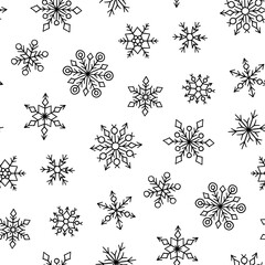 Seamless pattern with winter snowflakes. Hand drawn snowfall texture. Vector illustration in doodle style on white background.