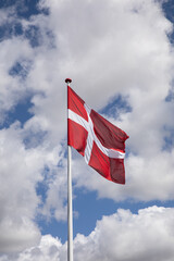 Danish flag with blue sky and clouds