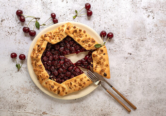Cut piece of sour cherry open pie or galette