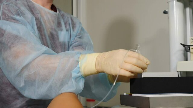 Ivf follicular puncture, female assistant doctor holding empty test tube for oocyte retrieved, nurse redy to pass plastic vial for pink media liquid, egg retrieval procedure. 4 k video
