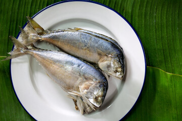 Steamed mackerel ripe, in white dish on banana leaf