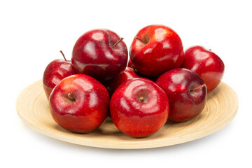Red apples on a bamboo plate