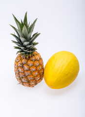 Ripe, fresh pineapple and yellow melon isolated on white background