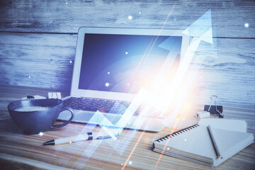 Computer on desktop with point up arrows hologram. Double exposure. Concept of success.