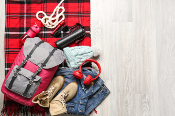 Set of traveler's accessories on wooden background