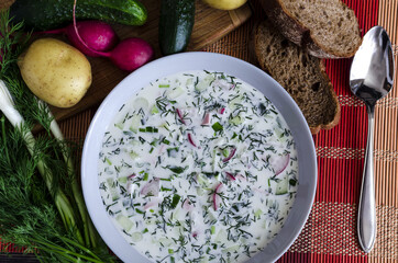 cold soup with vegetables and herbs based on milk and the products from which it is prepared top view