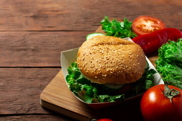 Ingredients for making a burger. Burger on a dark wooden background