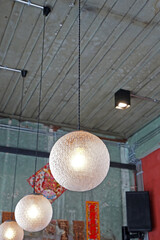 Interior design and decoration of industrial loft building decorated with row of hanging sphere lamps