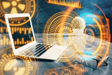 Computer on desktop in office with technology theme hologram. Multi exposure. Tech concept.