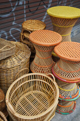 Rows and stacks of rattan weaving materials and furniture displayed on handmade craft store- Chiang mai, Thailand