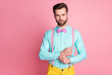 Portrait of his he nice attractive imposing elegant fashionable content serious bearded guy star celebrity fixing button cufflink preparing isolated over pink pastel color background