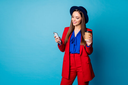 Photo Of Attractive Lady Hold Telephone Hands Read Corporate Email Message Good News Drink Takeout Coffee Wear Red Blazer Trousers Suit Retro Hat Isolated Blue Color Background