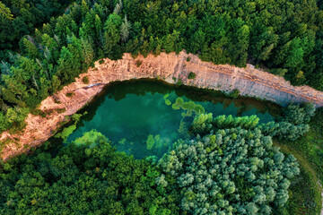 Aerial photo of a green mountain lake at sunset