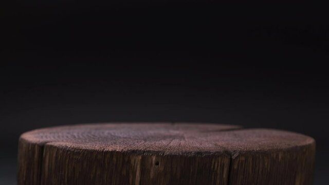 Empty dark wooden table for product presentation on black background, 4K UHD video footage