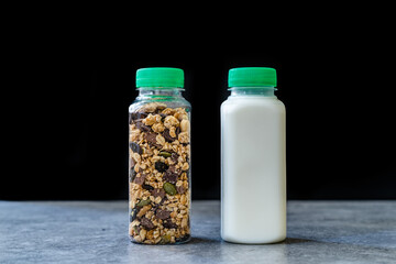 Roasted Granola in Plastic Bottle with Pumpkin Seeds, Chocolate Drops, Honey and Milk.