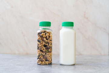 Roasted Granola in Plastic Bottle with Pumpkin Seeds, Chocolate Drops, Honey and Milk.