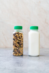 Roasted Granola in Plastic Bottle with Pumpkin Seeds, Chocolate Drops, Honey and Milk.