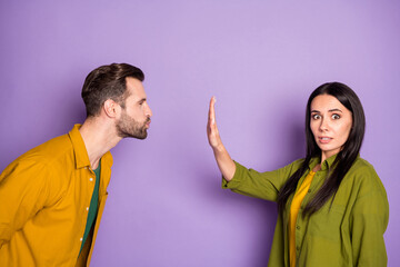 Profile photo of lady guy couple boyfriend wait contact want kissing responsible girlfriend stop him raise arm keep distance terrified wear colorful shirts isolated purple color background