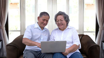 asian grandmother chating online with tablet