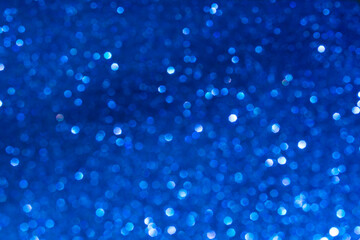 Glamor blue sparkling background. Blured glitter background. Holiday abstract texture. Background of blue lights.