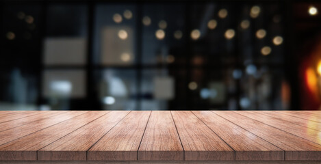 Empty wooden table top with lights bokeh on blur restaurant background