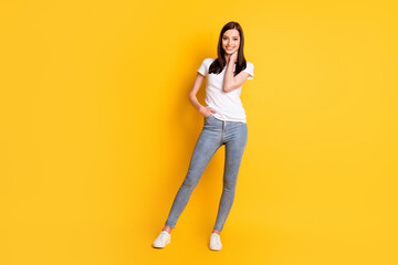 Fototapeta na wymiar Full length body size view of her she nice attractive lovely cheerful cheery brown-haired girl wearing casual clothes posing enjoying spring isolated bright vivid shine vibrant yellow color background