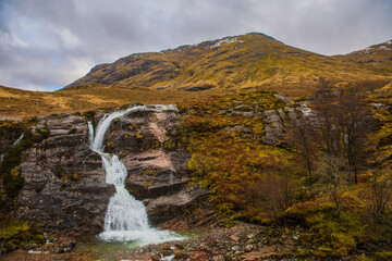 Fototapeta na wymiar Scottish landscape with a waterfall in the foreground