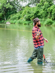 Fototapeta na wymiar The best time to go fishing. summer weekend. Big game fishing. mature man fly fishing. man catching fish. hobby and sport activity. pothunter. bearded fisher in water. fisherman with fishing rod