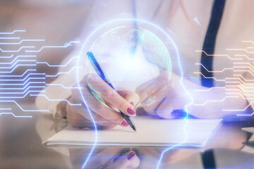 Multi exposure of woman's writing hand on background with brain hud. Concept of learning.