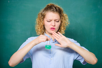 High school classes. College student performing chemical reaction. Chemical liquid smelling really bad. Disgusting experiment. Girl student dislike chemistry. Student practicing on hateful lesson