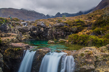 Fototapeta na wymiar Trekking across the Highlands of Scotland to stumble upon this magnificent sight - The Fairy Pools