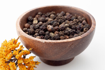 Thyme grains in white background and wooden presentation bowl