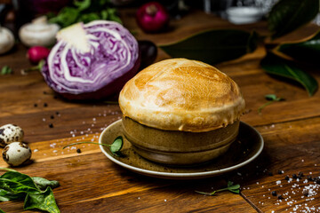 Siberian roast in pots, with potatoes and mushrooms, lid of dough