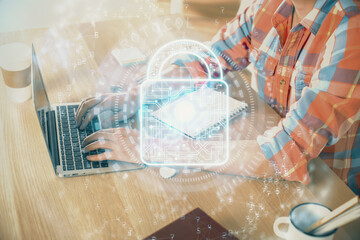 Double exposure of lock icon with man working on computer on background. Concept of network security.