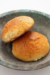 Fresh muffin in white background and old copper bowl