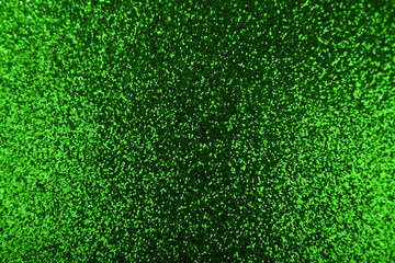Green glittering shiny festive background with texture.