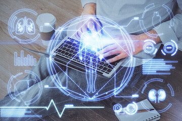 Science hologram with man working on computer on background. Concept of study. Double exposure.